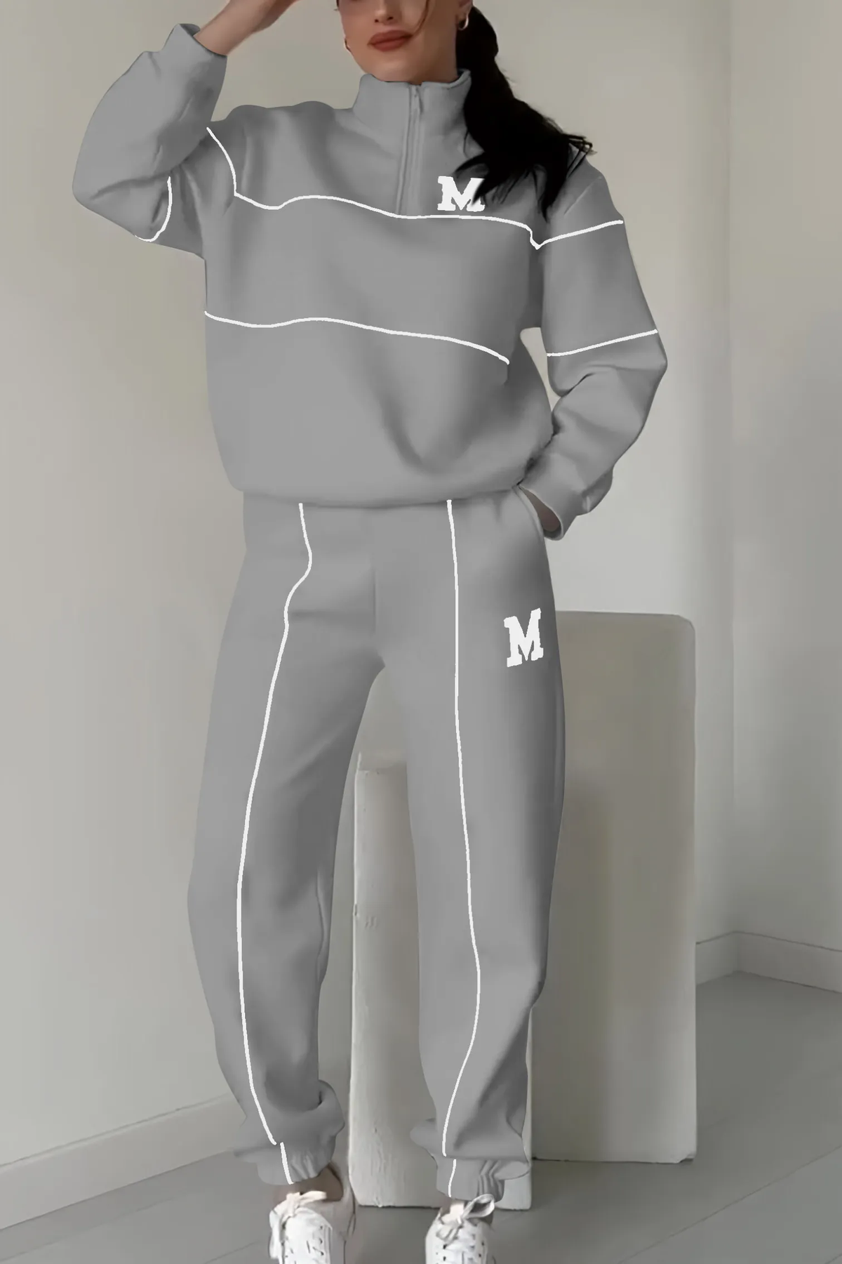Gray tracksuit with white piping and quarter-zip pullover