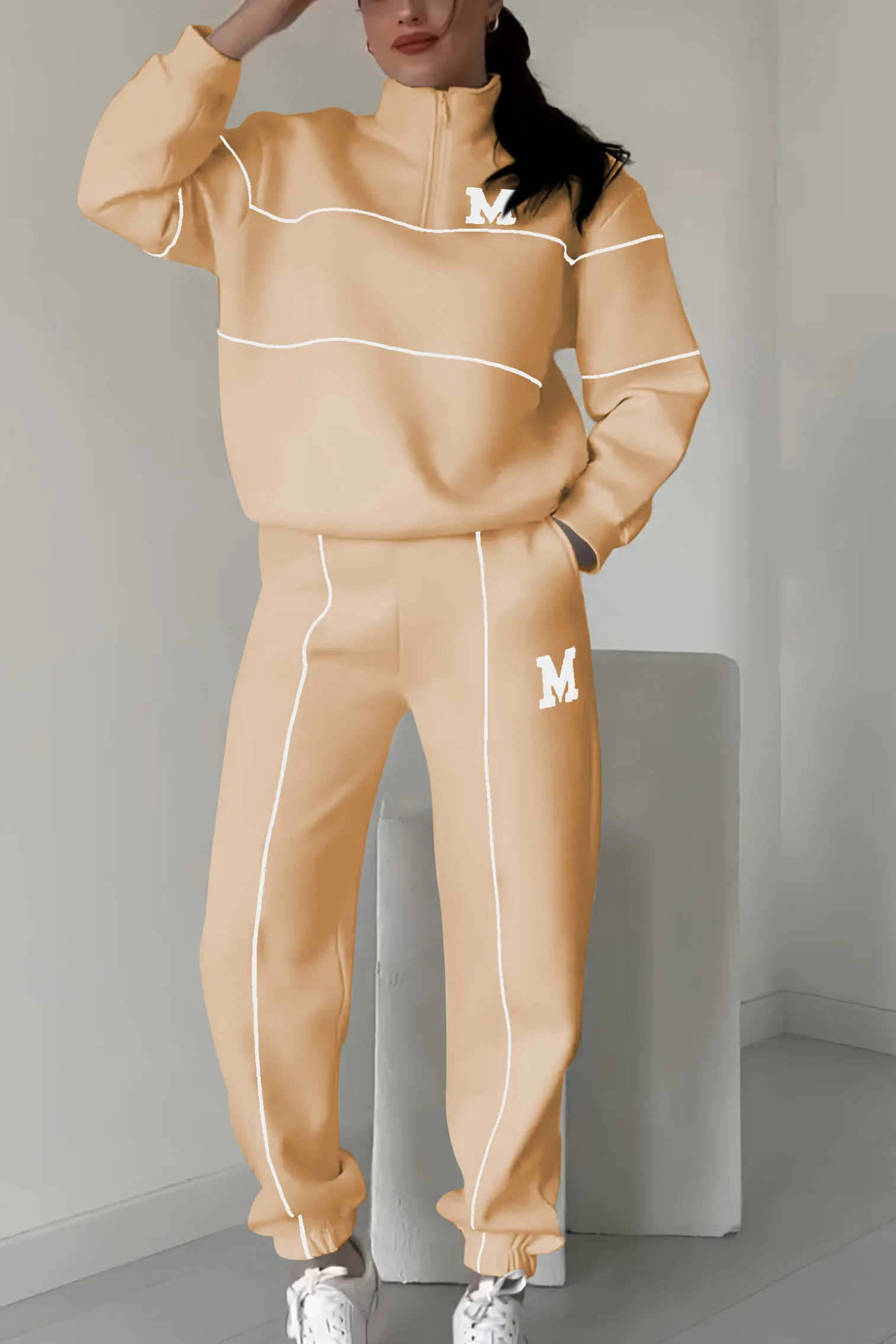 Peach tracksuit with white contrast trim and M emblem