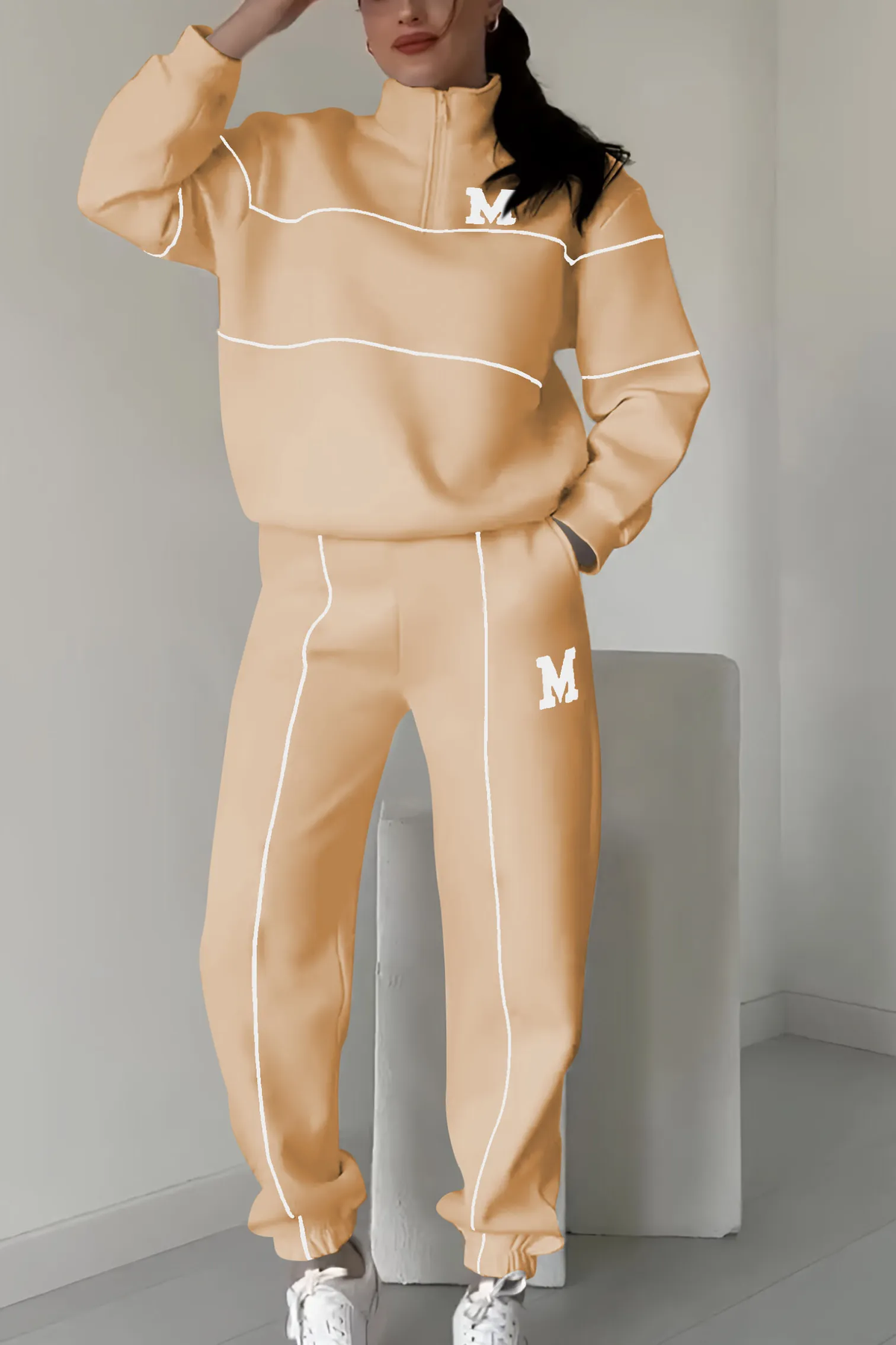 Peach tracksuit with white contrast trim and M emblem