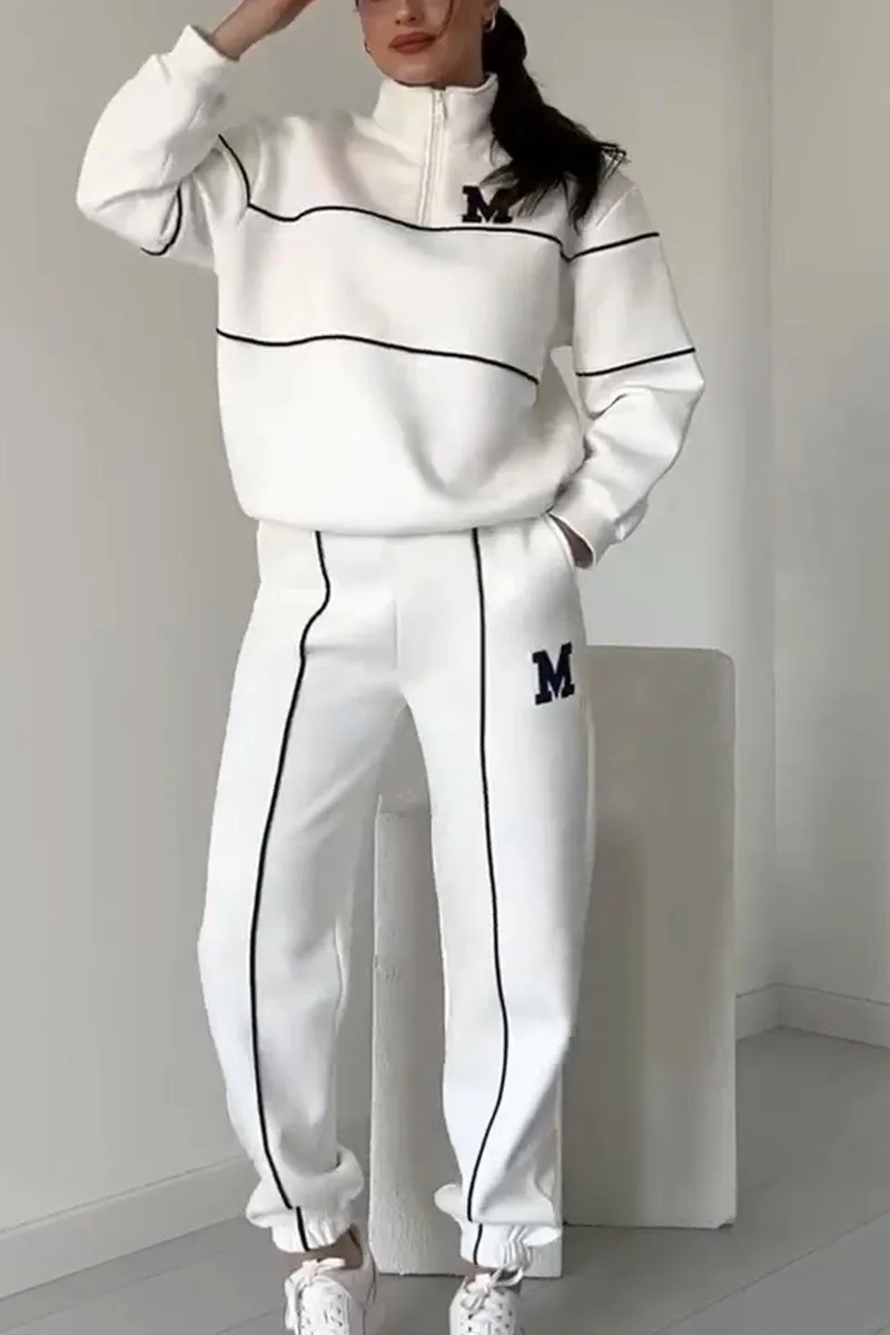 White tracksuit with black contrast piping and quarter-zip top