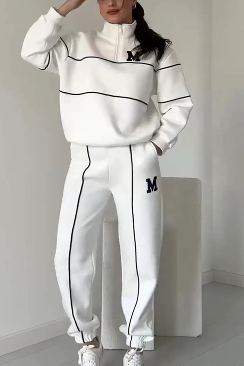 White tracksuit with black contrast piping and quarter-zip top