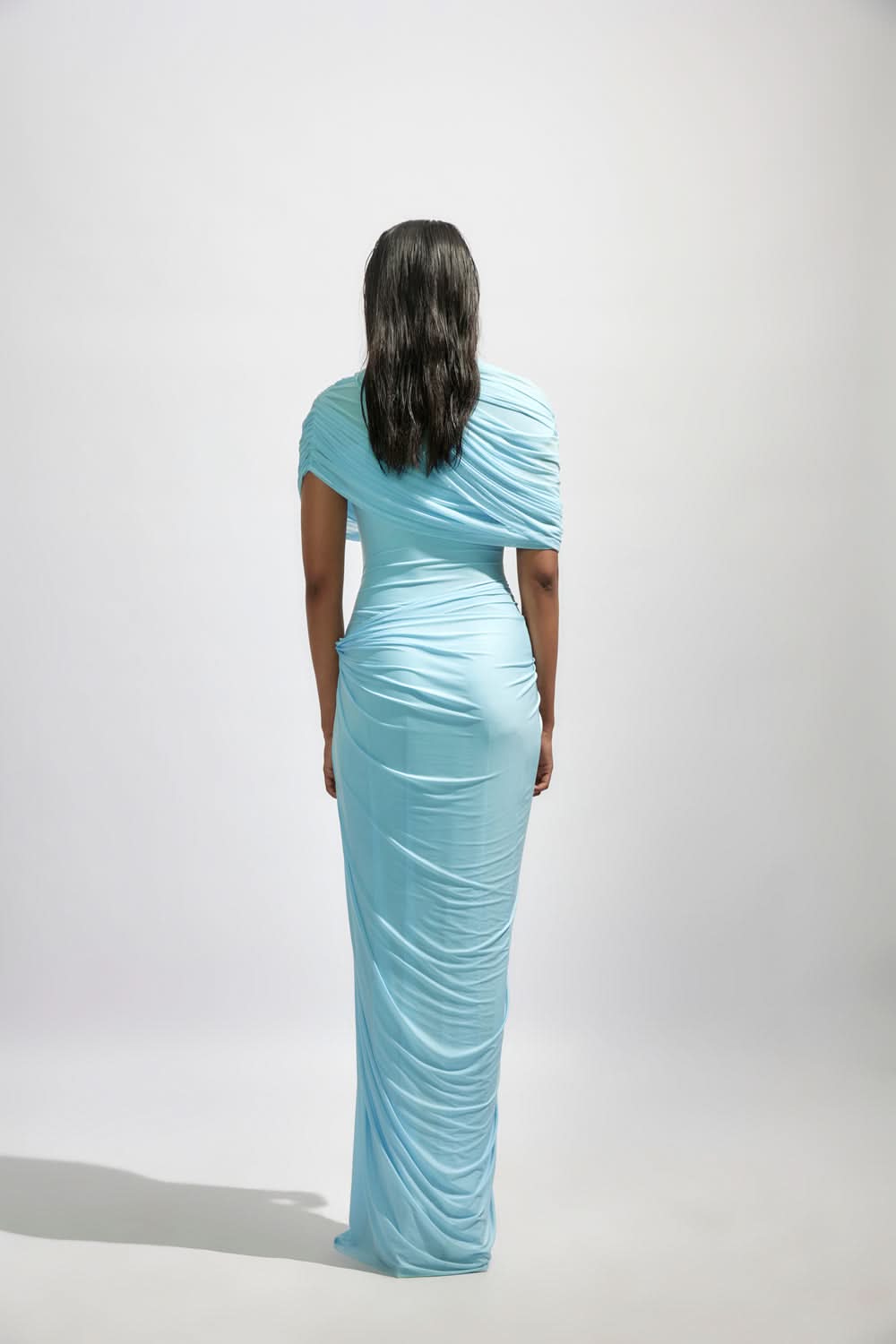 Back view of light blue wrap maxi dress with ruched fabric and long train