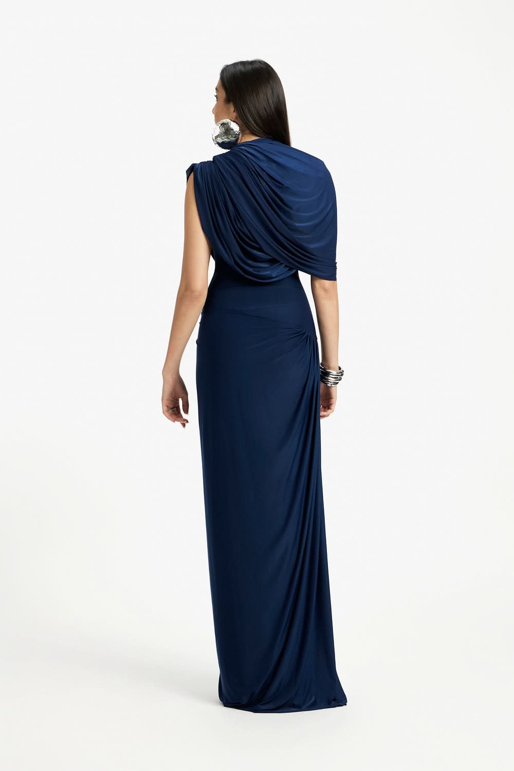 Back view of navy wrap maxi dress showing draped cape overlay