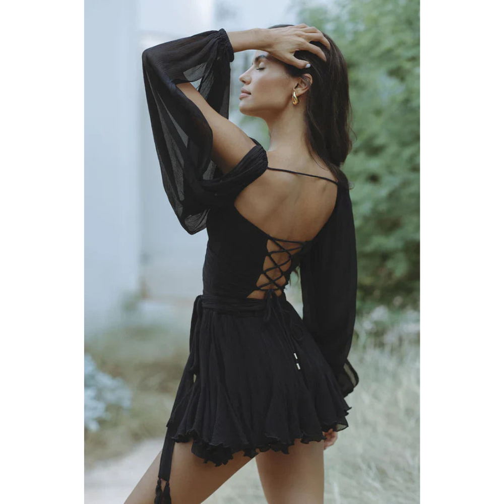 Black mini dress with lace-up open back and flowing long sleeves
