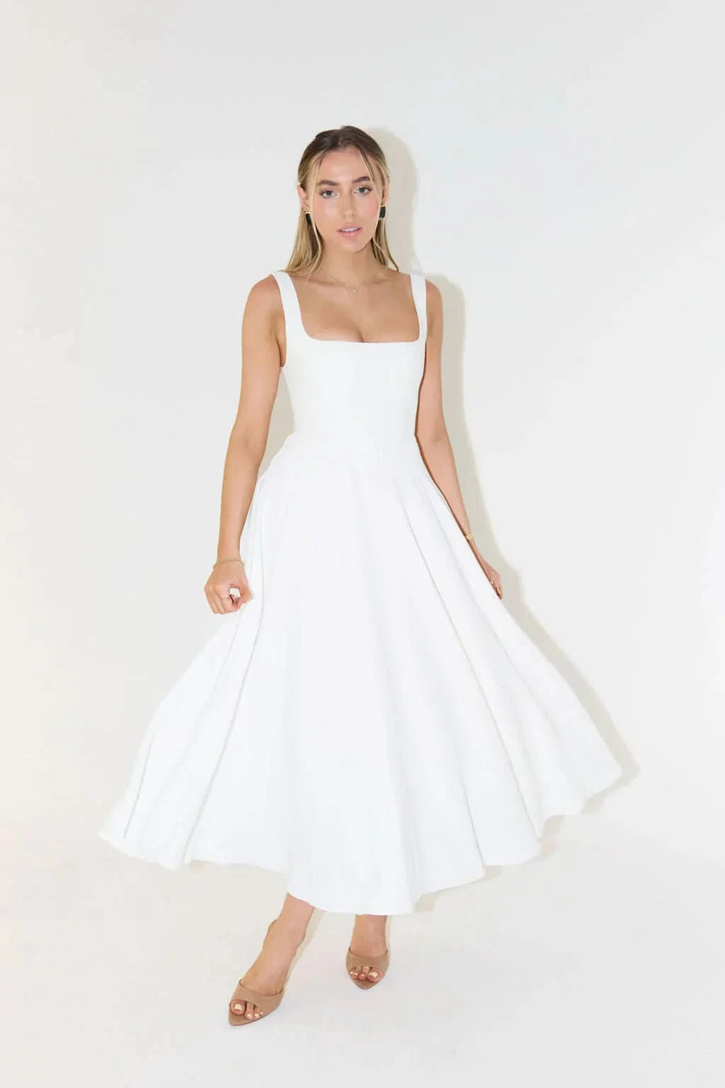 White sleeveless midi dress with square neckline and flowing A-line skirt
