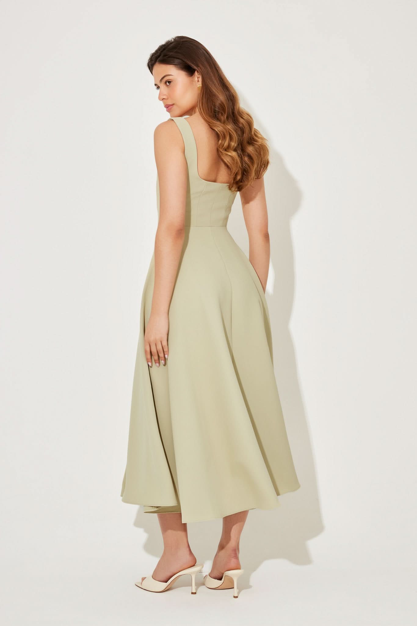 Back view of pale yellow midi dress showing open back design