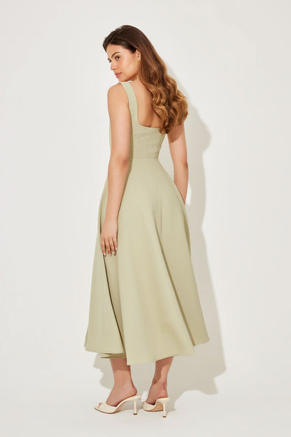 Back view of pale yellow midi dress showing open back design