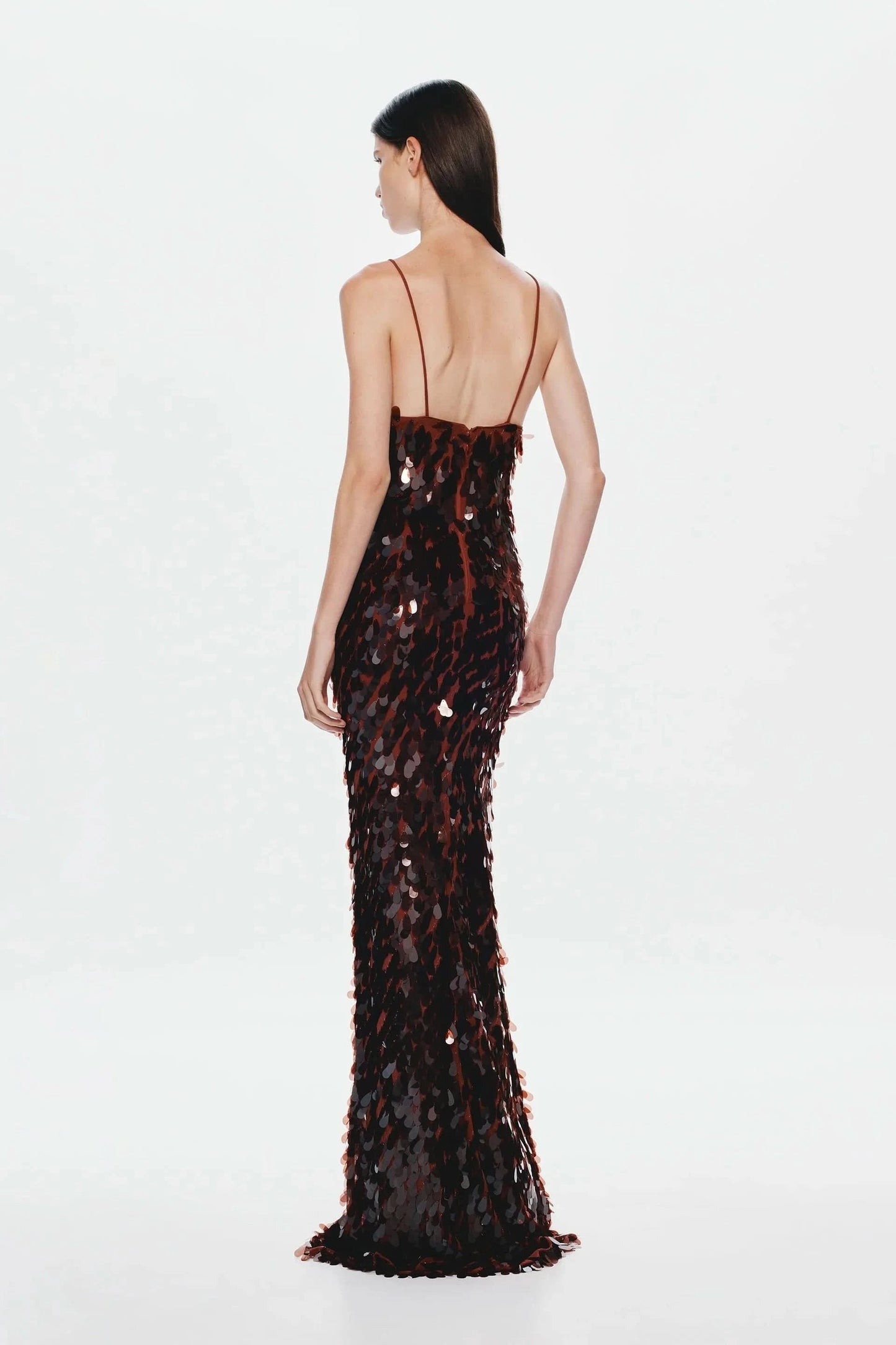 Back view of black and red sequined maxi dress with open back