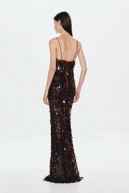 Back view of black and red sequined maxi dress with open back