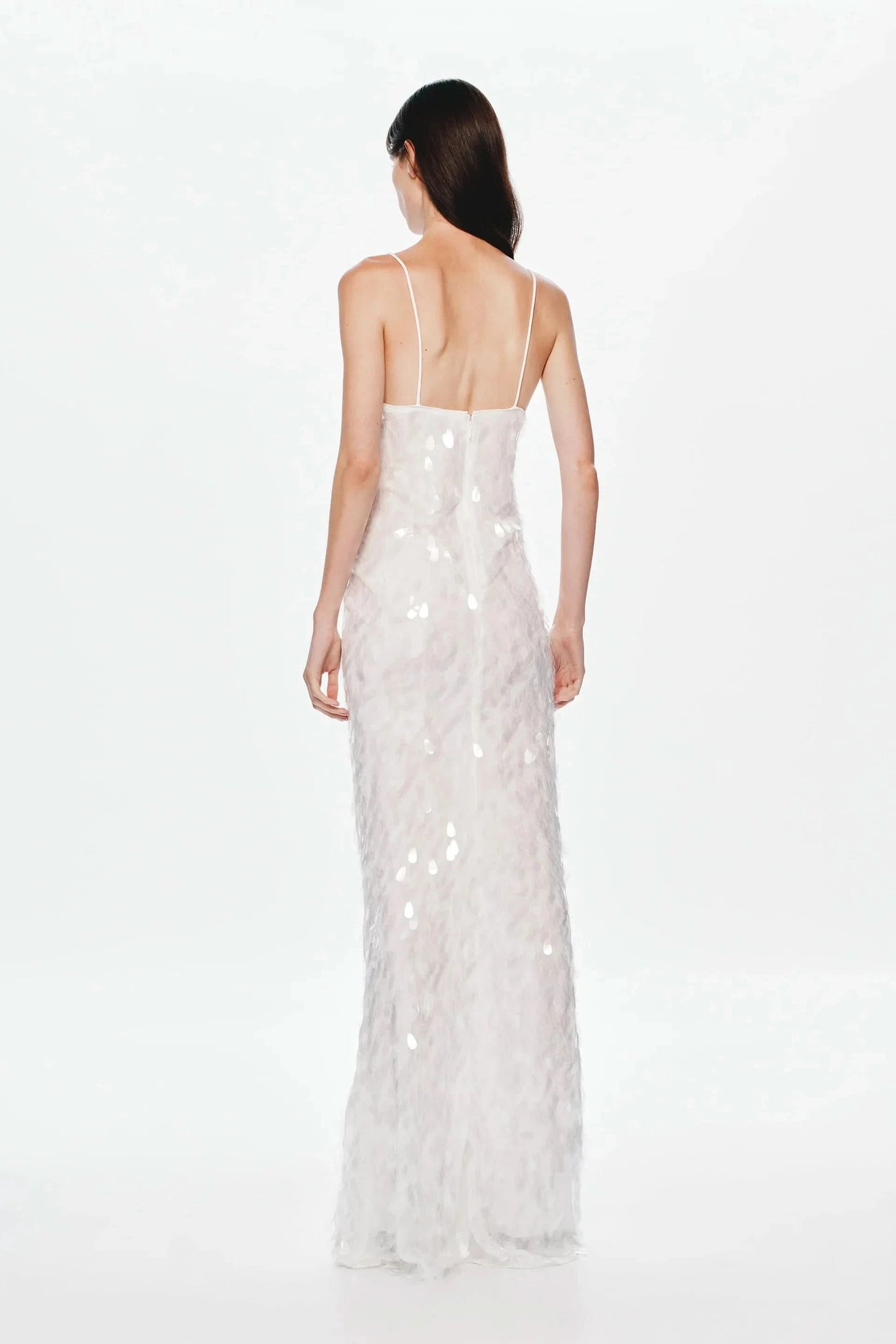 Back view of cream sequined maxi dress with low back design
