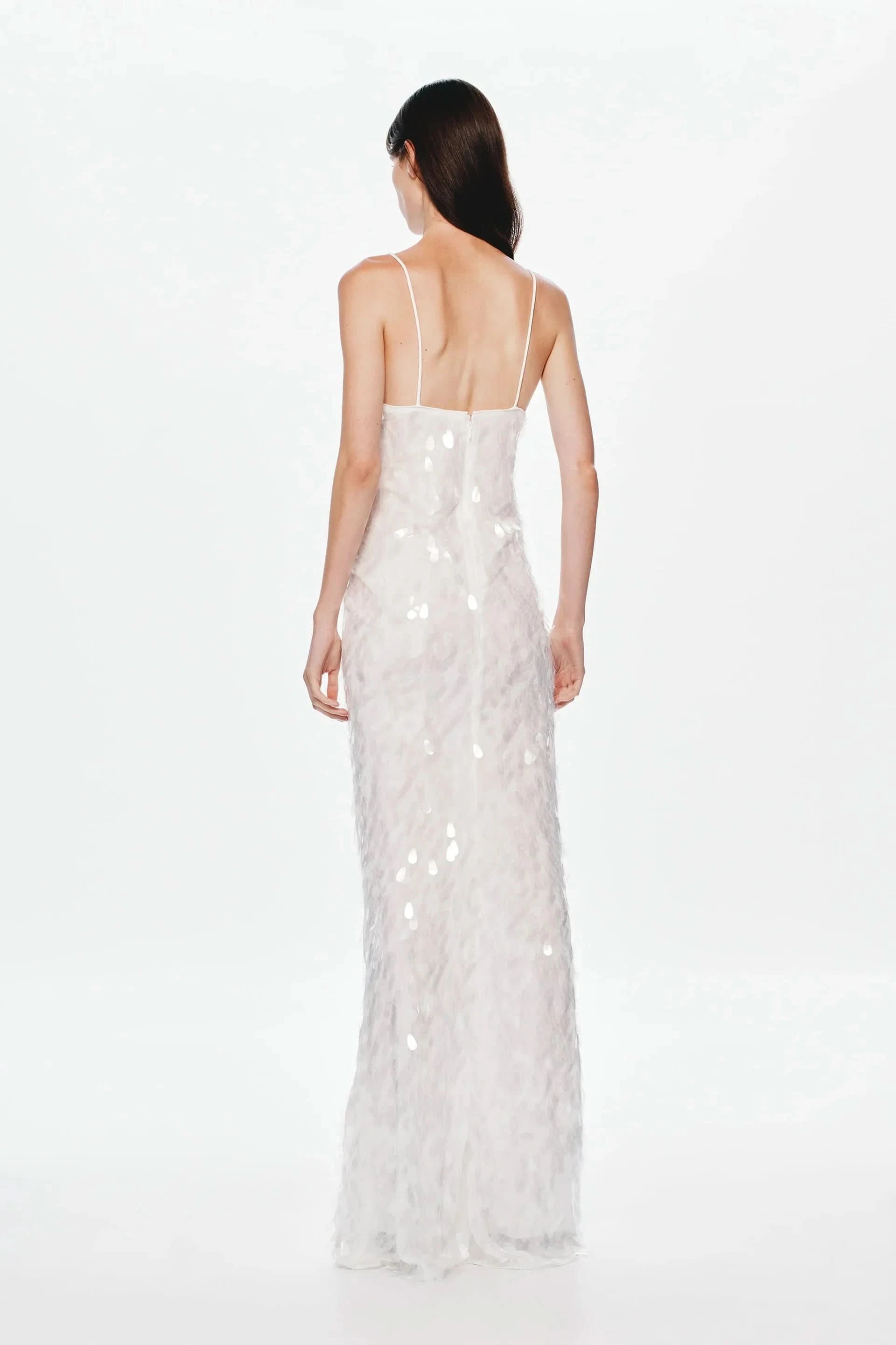 Back view of cream sequined maxi dress with low back design