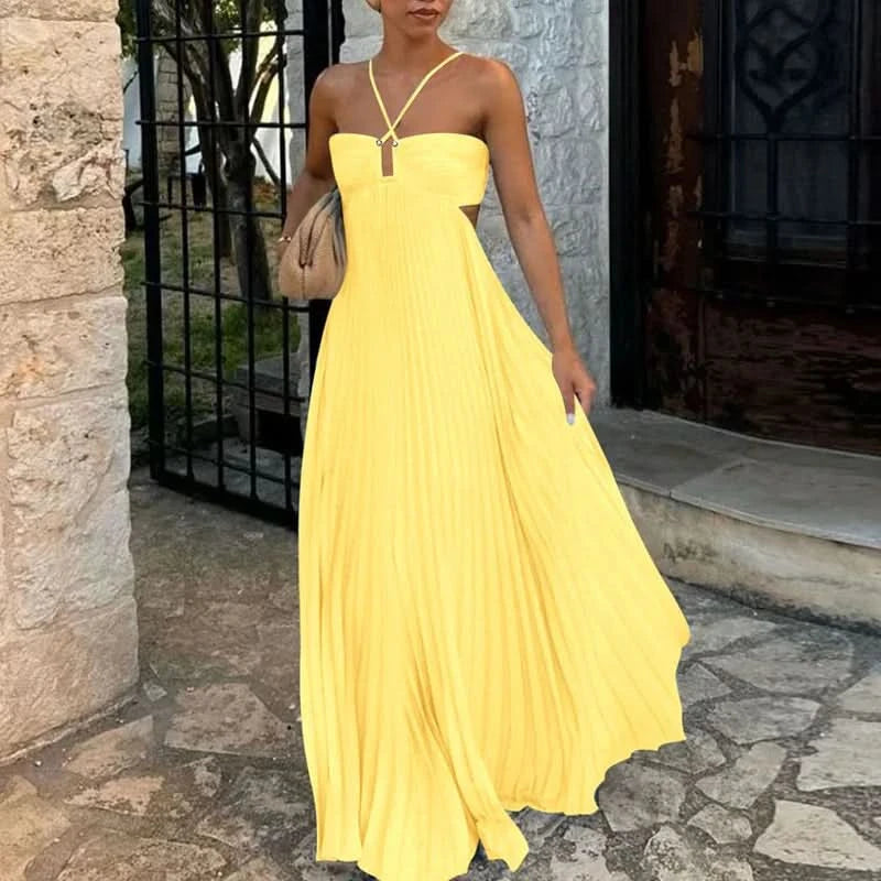 Bright yellow halter maxi dress with pleated skirt worn outdoors