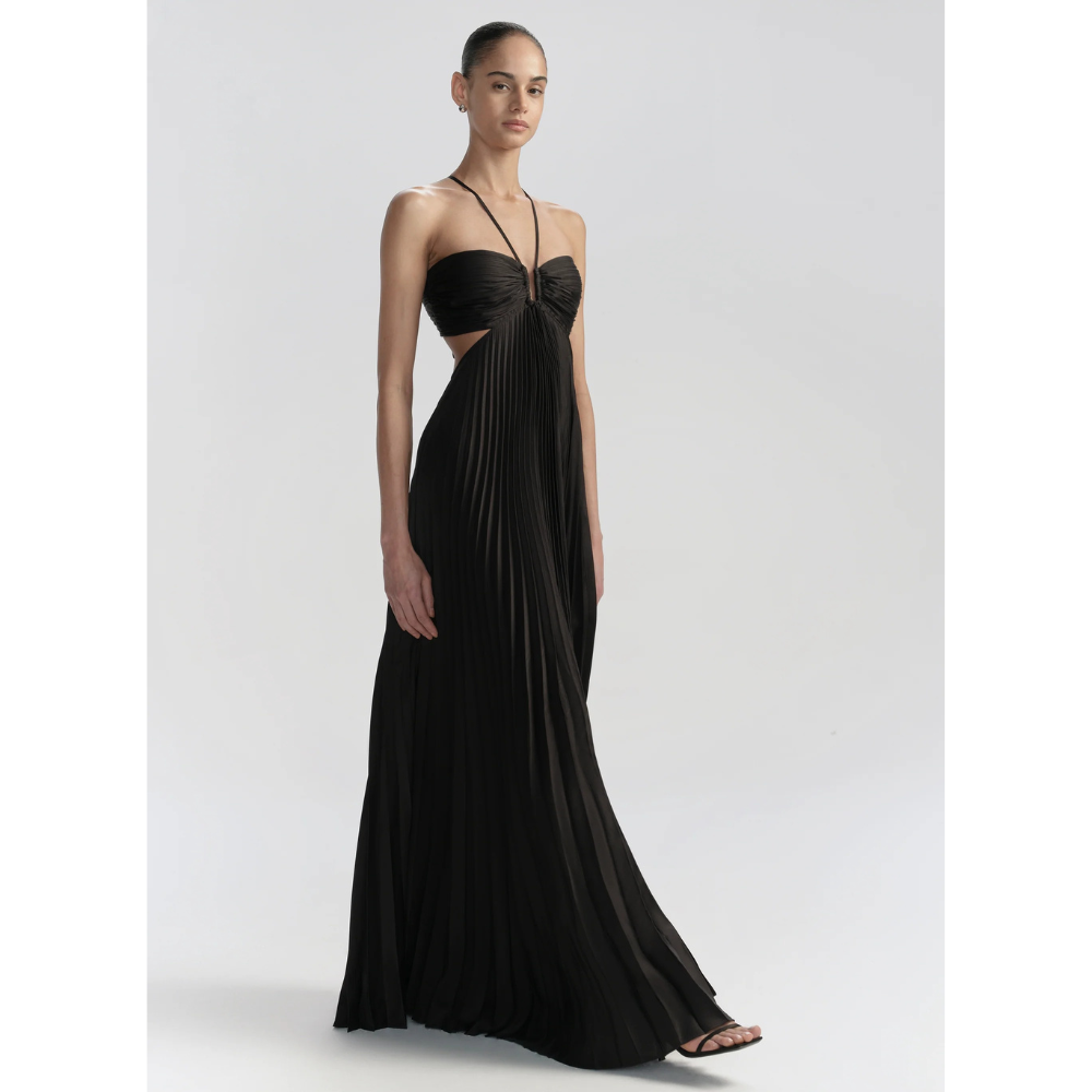 Black pleated halter maxi dress with cutout sides and flowing floor-length skirt