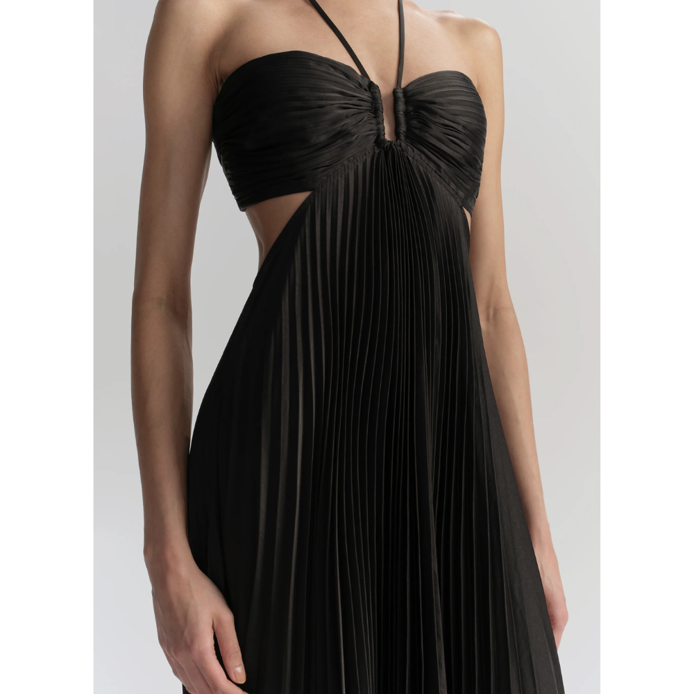 Close-up of black halter neckline with crossed straps and pleated bodice texture