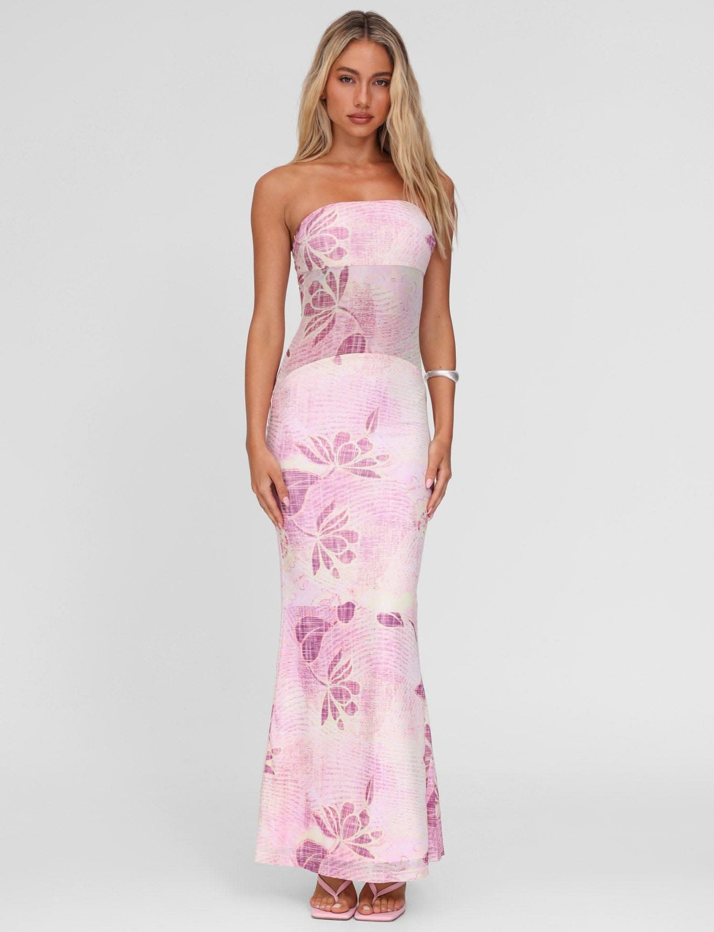 Front view of pink floral strapless maxi dress with sheer waist panel