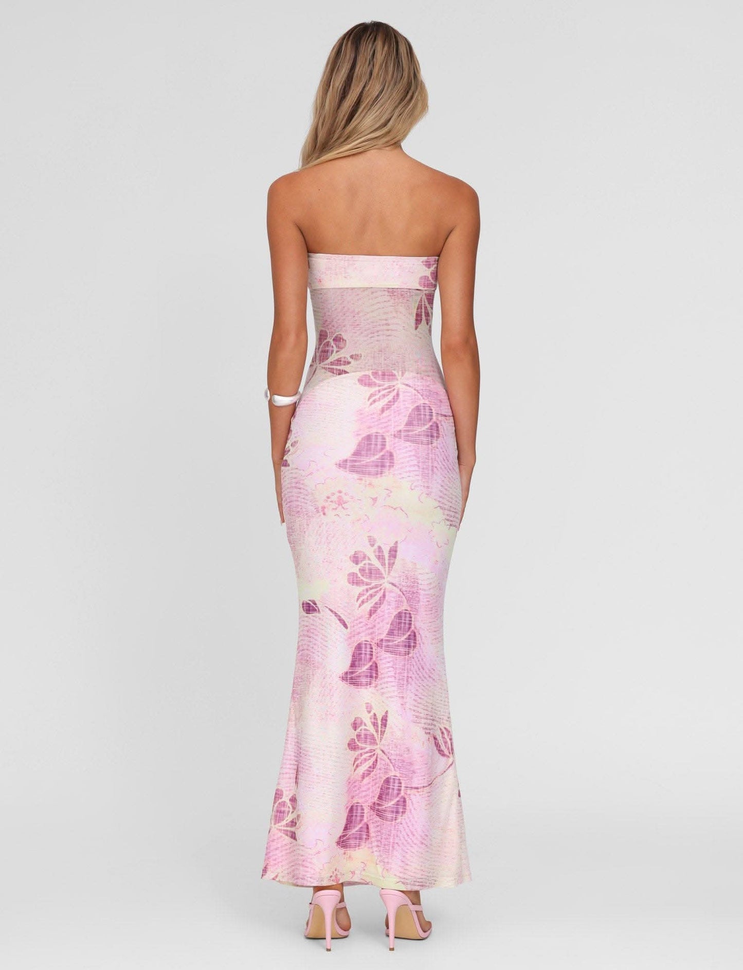 Back view of pink floral strapless maxi dress showing open back