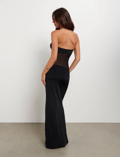 Back view of black strapless maxi dress with sheer midsection detail