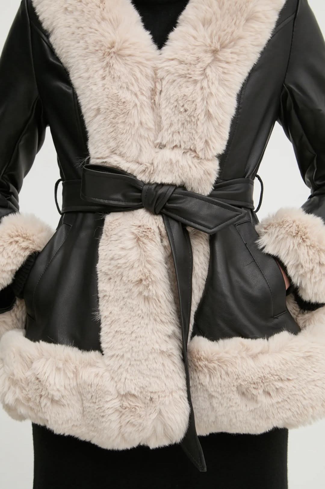 Close-up of cream faux fur shawl collar and black leather tie belt detail