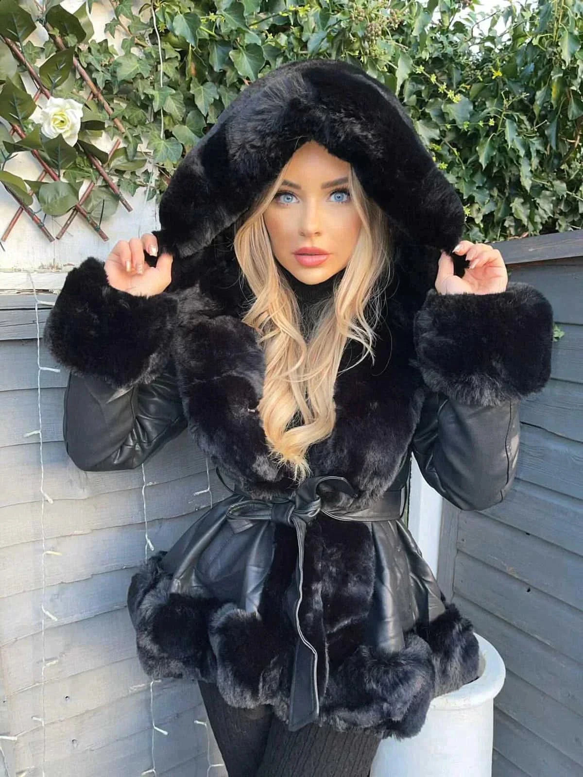 Black leather faux fur coat with oversized hood and black fur trim detail
