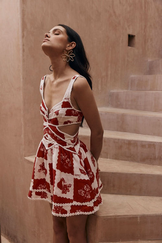 Red and white floral mini dress with cutout waist and pearl trim details