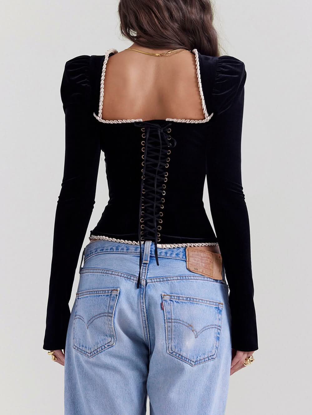 Backless black velvet corset with lace-up closure and puffed shoulders