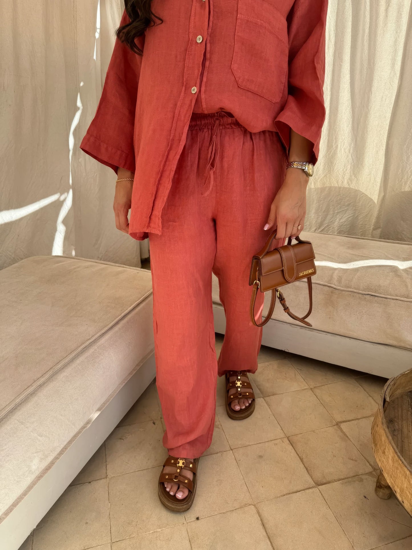 Coral red linen pants with drawstring waist and straight-leg cut, full-length view