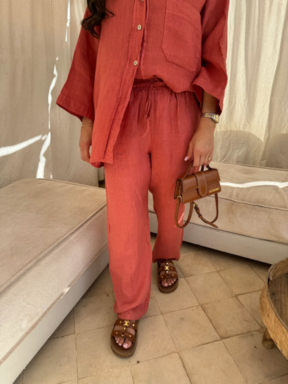 Coral red linen pants with drawstring waist and straight-leg cut, full-length view