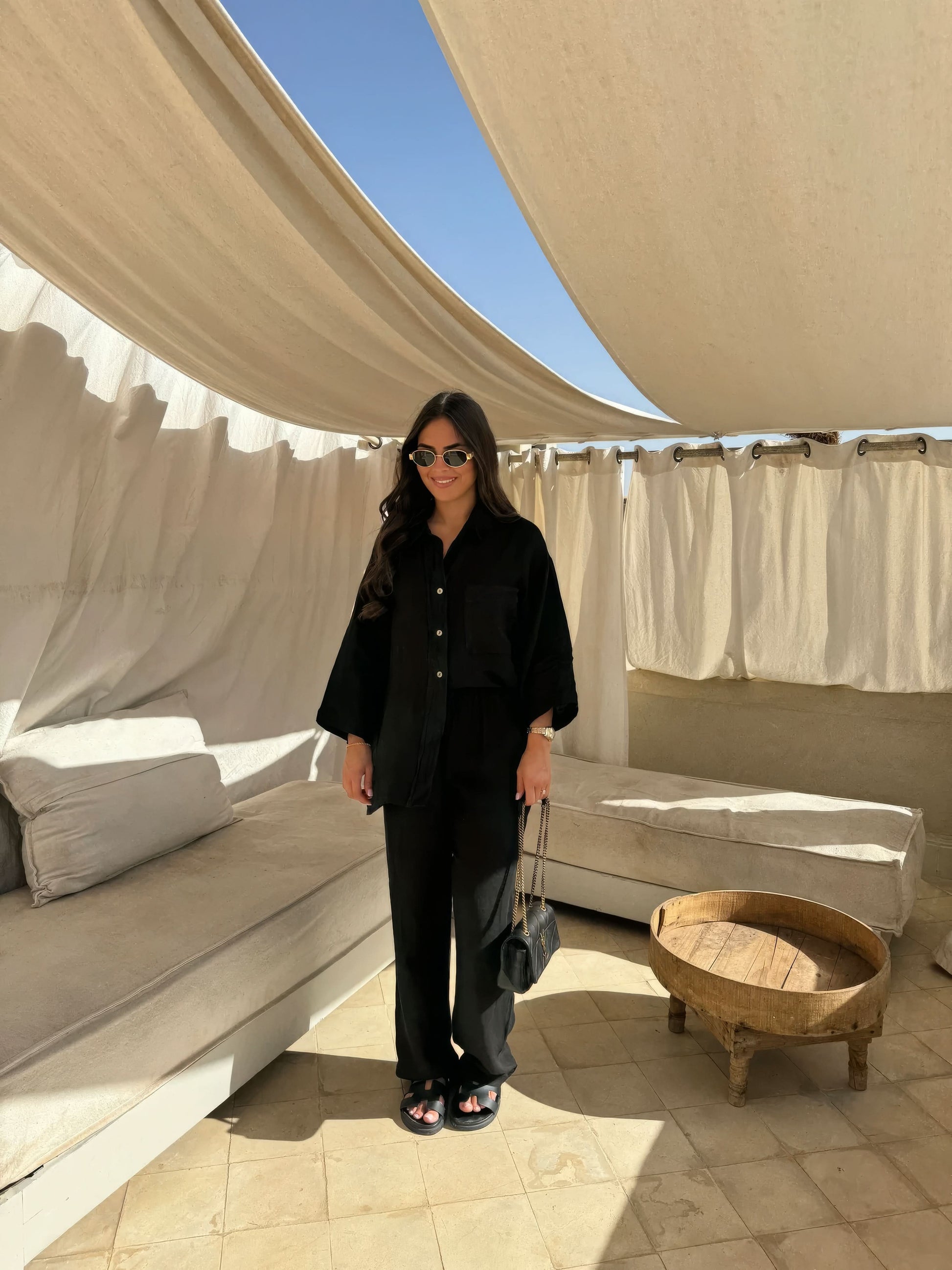 Black linen button-front shirt and wide-leg pants ensemble