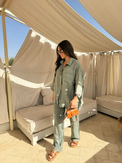 Side view of sage green linen suit showing relaxed shirt silhouette and straight-leg pants
