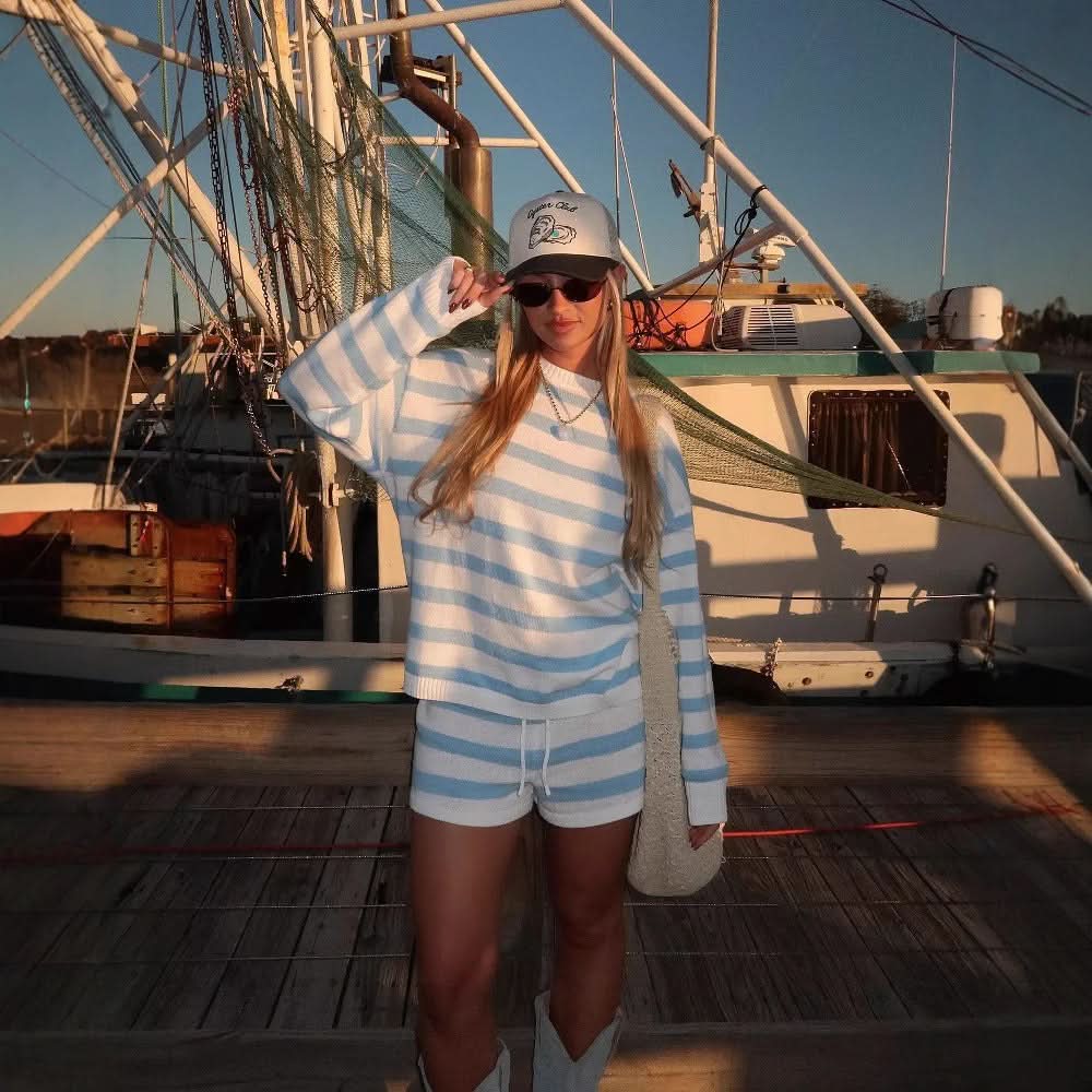 Blue and white horizontal stripe knit sweater and shorts on boat