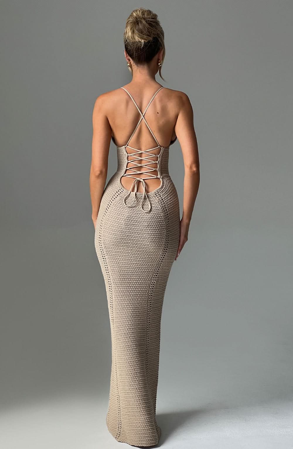 Beige knit maxi dress back view with crisscross lacing and perforated texture throughout