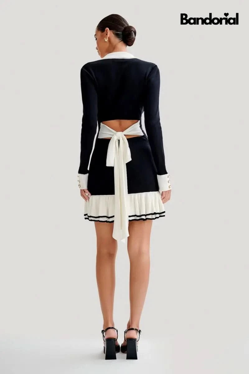 Back view of black cutout mini dress with cream tie waist detail and pleated skirt for women