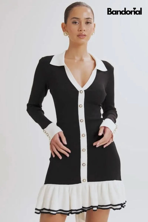 Black mini dress with cream collar, long sleeves, button-front, and pleated white skirt hem for women