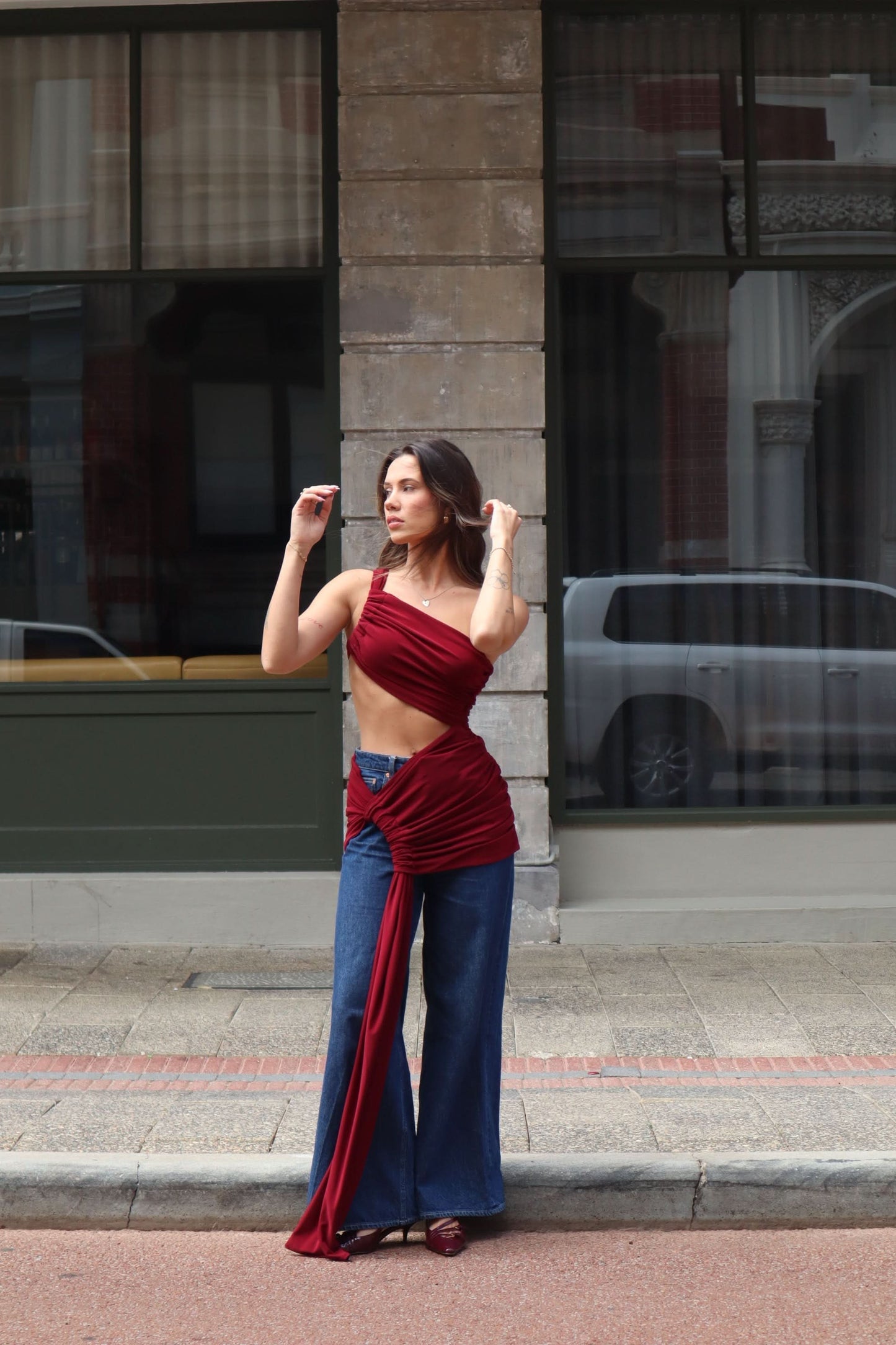 Burgundy lace maxi dress styled with denim and flowing fabric detail