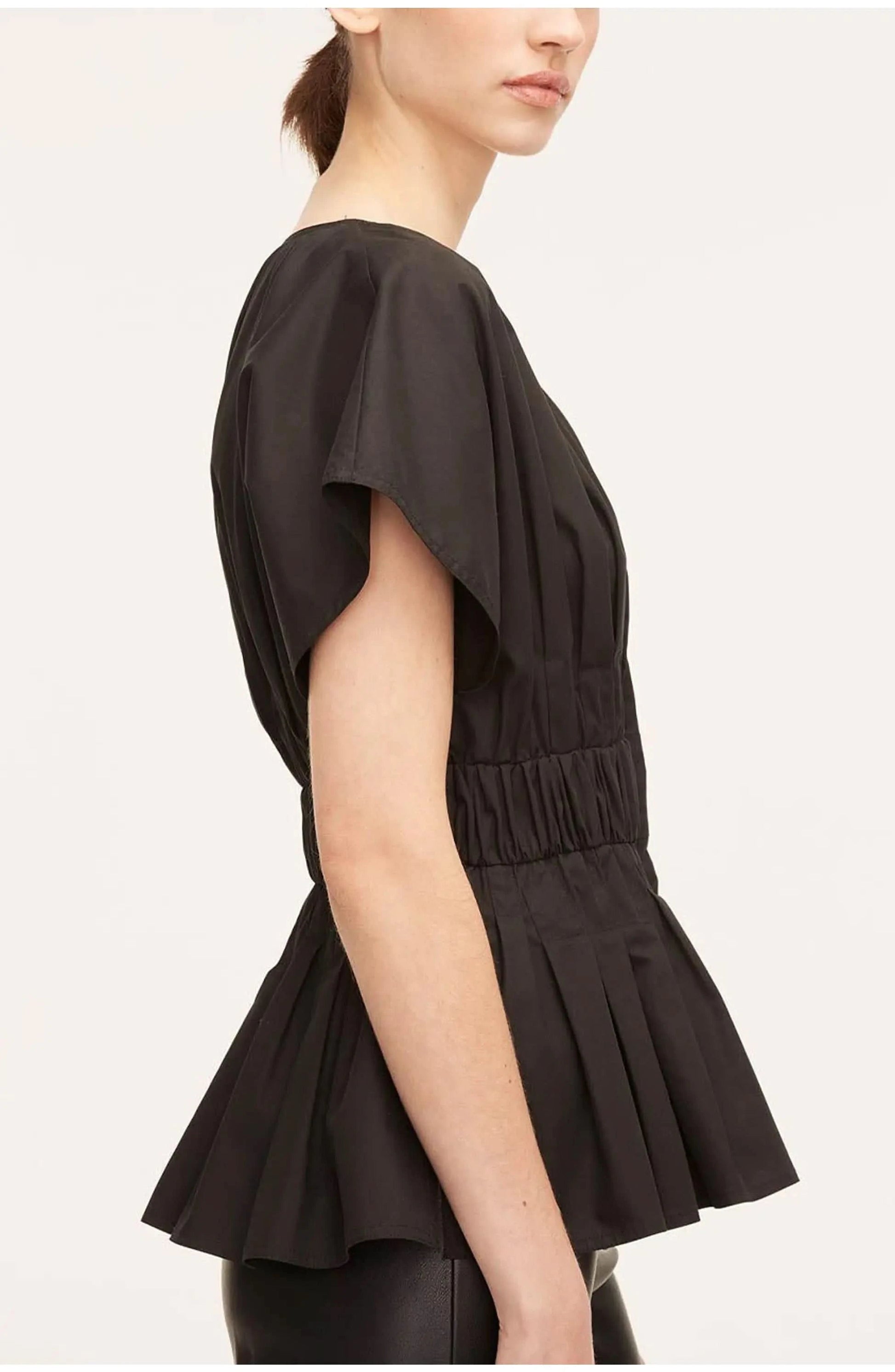 Side view of black blouse showing peplum ruched waist detail and voluminous short sleeves