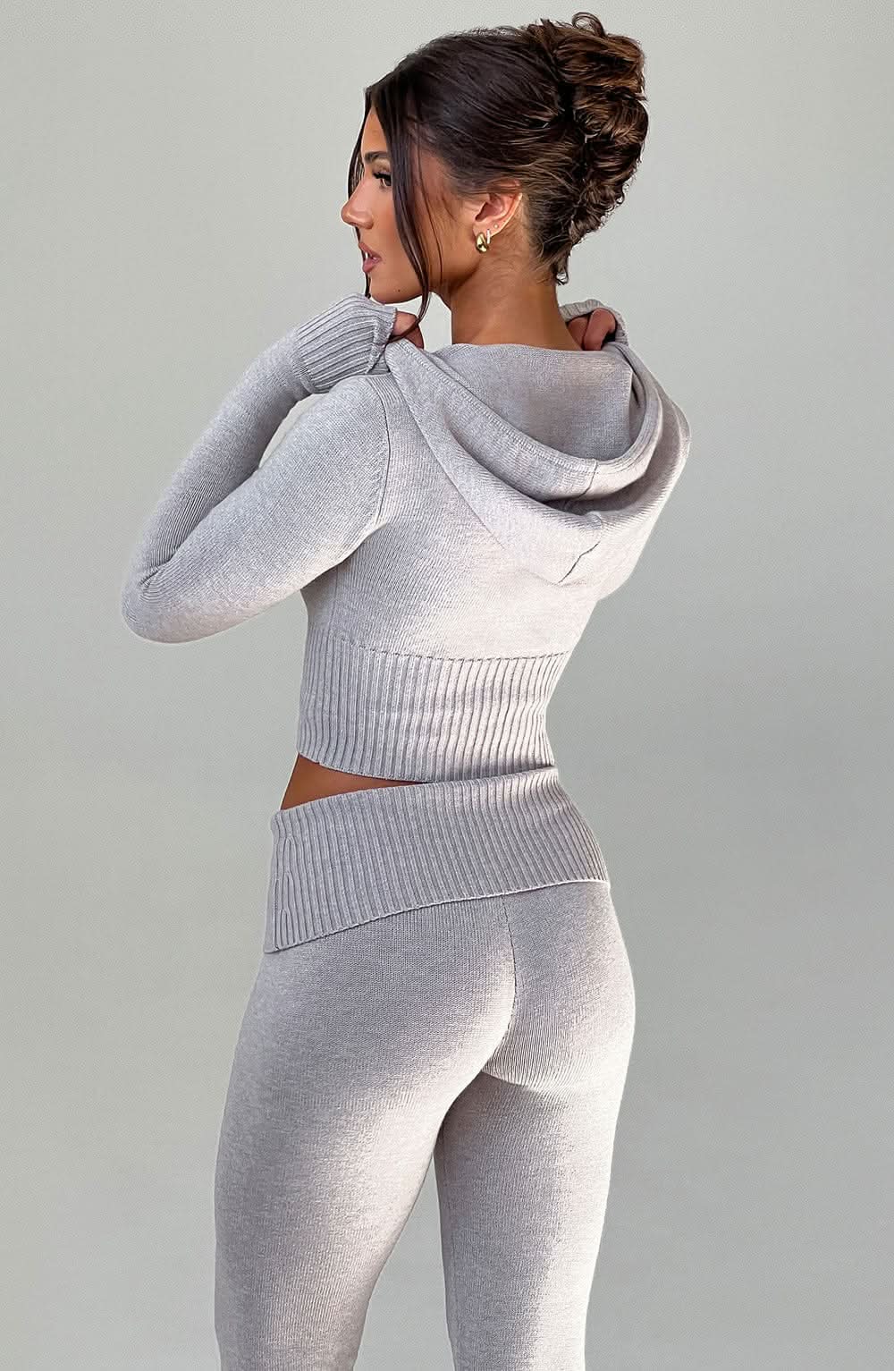 Back view of gray knit set showing hooded crop top and fitted leggings