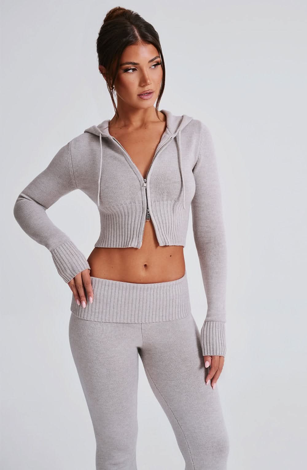 Close-up front view of gray knit hoodie crop top with ribbed texture detail