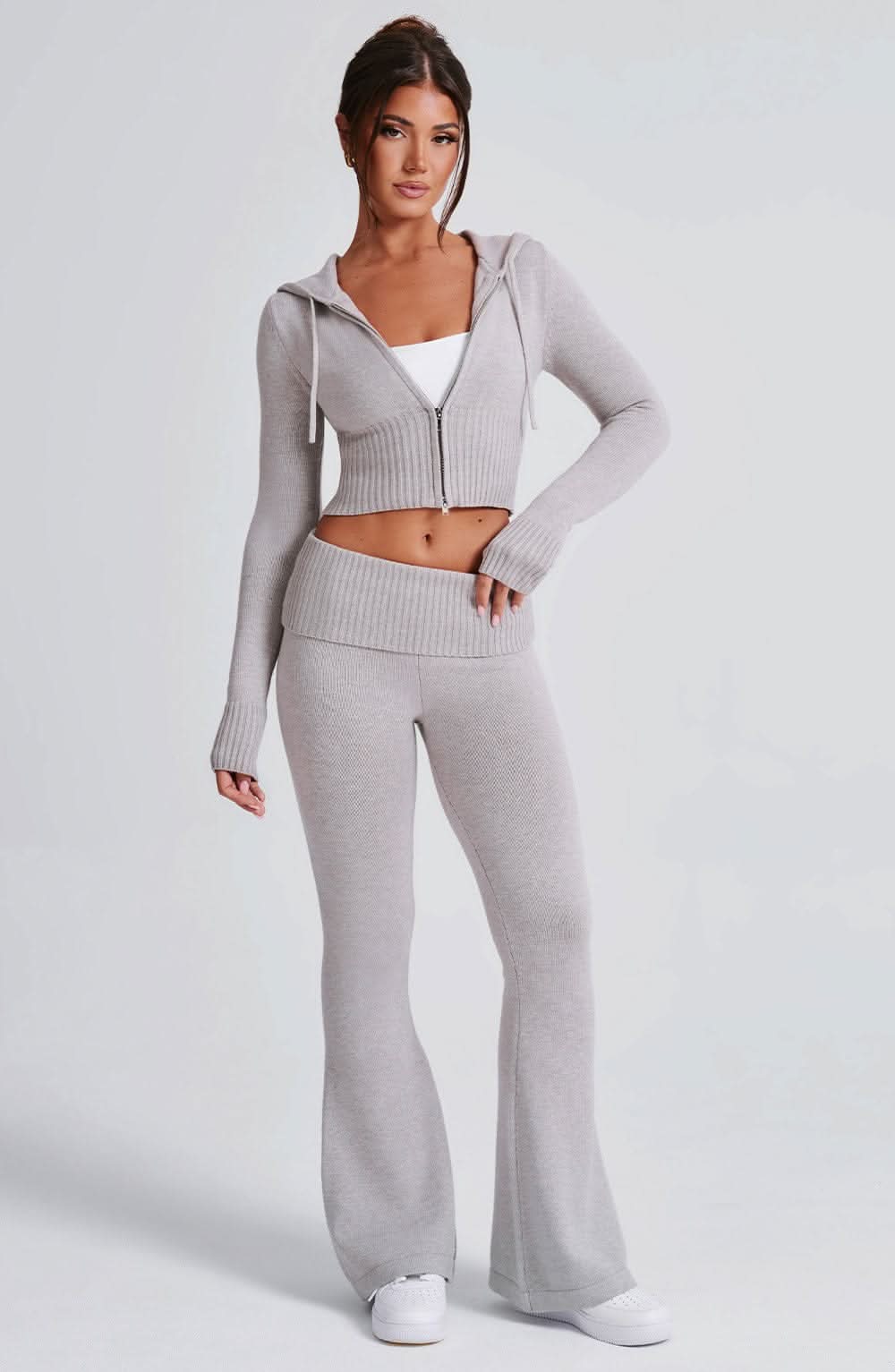 Side profile of gray ribbed knit crop hoodie and matching fitted leggings