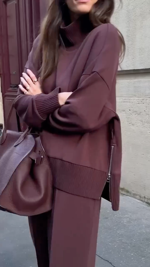 Side profile of burgundy knit sweater and trousers with ribbed trim accents