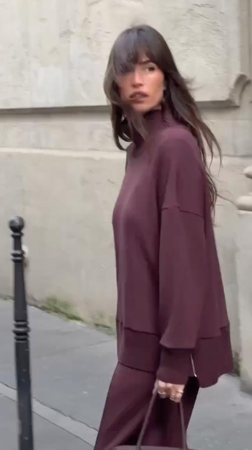 Back view of burgundy knit set showing relaxed fit sweater and straight-leg pants
