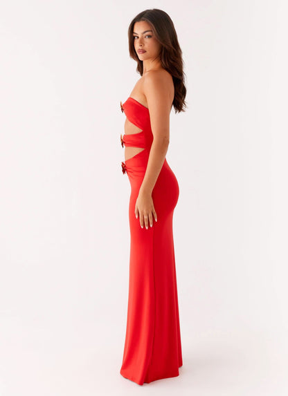 Side view of red evening gown with strapless design and gold embellished side cutouts