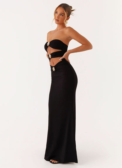 Black strapless maxi dress with gold ornament cutout details and fitted silhouette