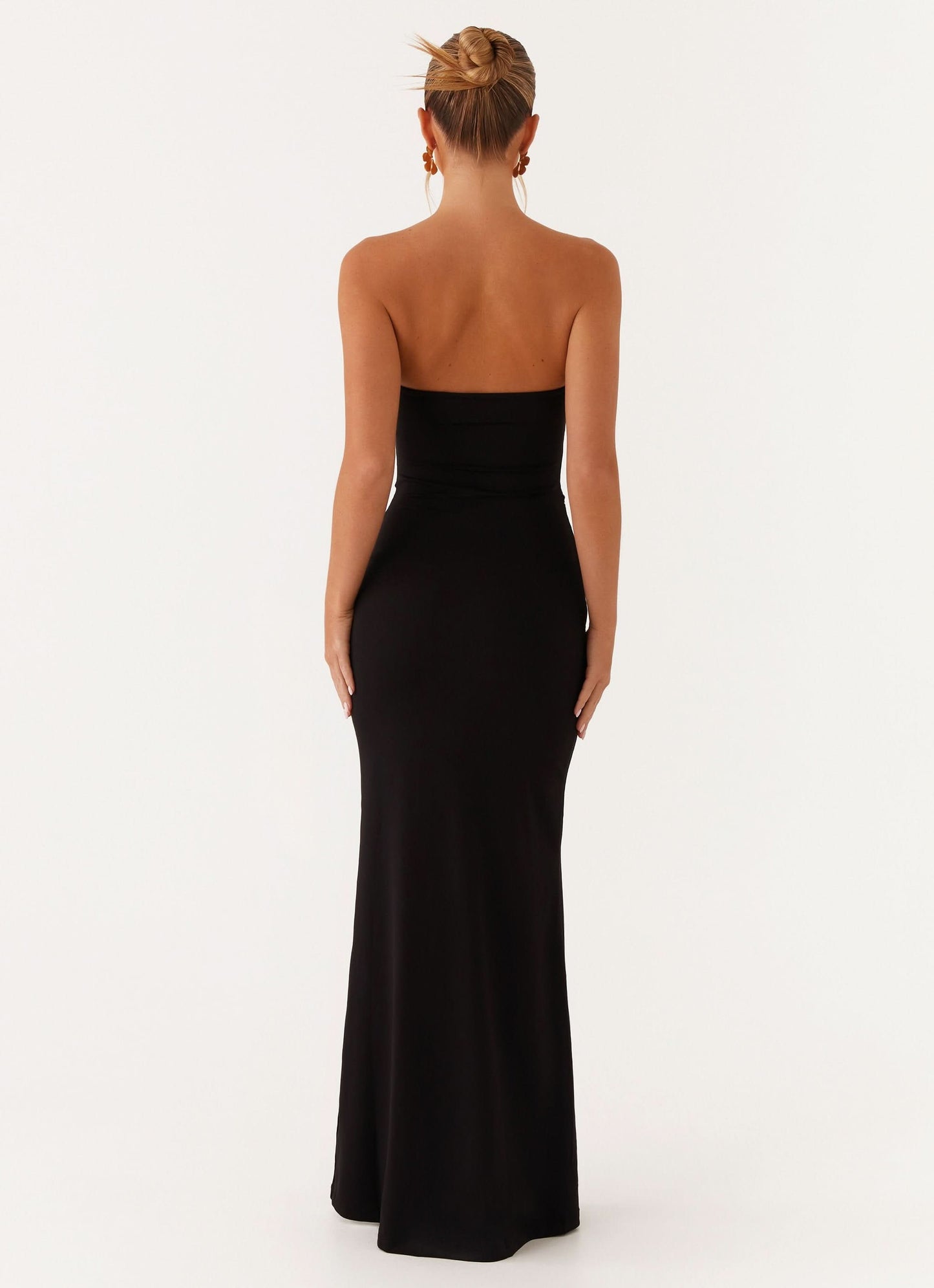 Back view of black evening gown with strapless design and floor-length hem
