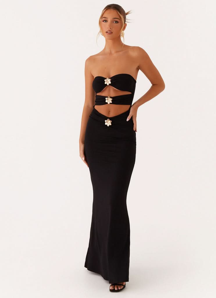 Back view of black evening gown with strapless design and floor-length hem