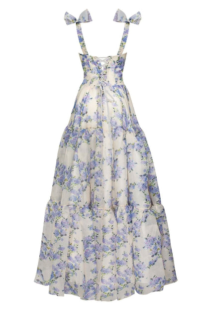 Back view of floral maxi dress with bow shoulder straps and layered skirt