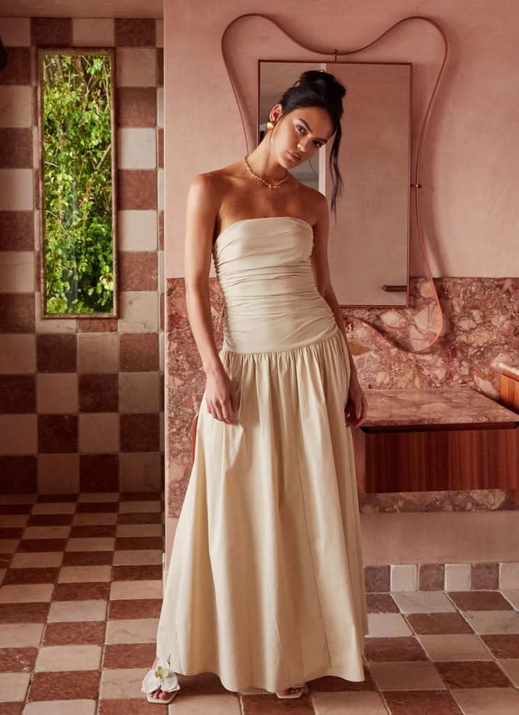 Full-length cream strapless maxi dress with gathered waistband detail