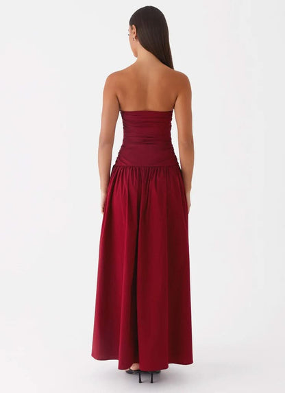Burgundy strapless maxi dress with ruched bodice and flowing skirt, back view