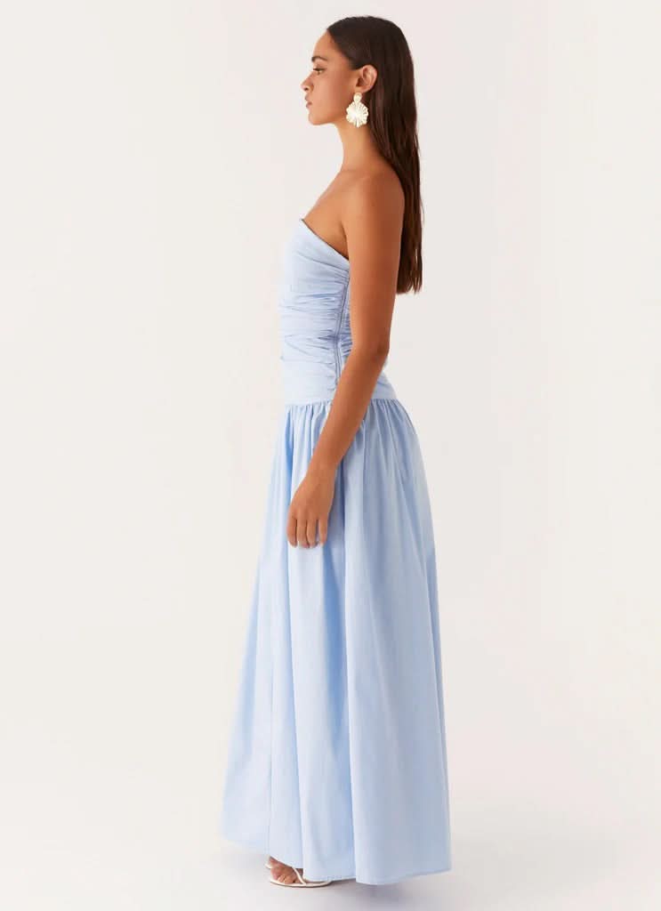 Light blue strapless maxi dress with ruched waist detail, profile view