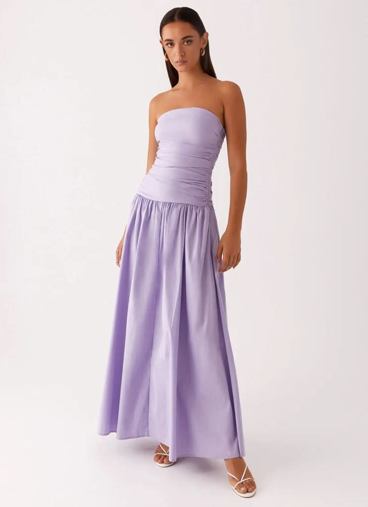 Lavender strapless maxi dress with ruched waist and flowing skirt, full length view