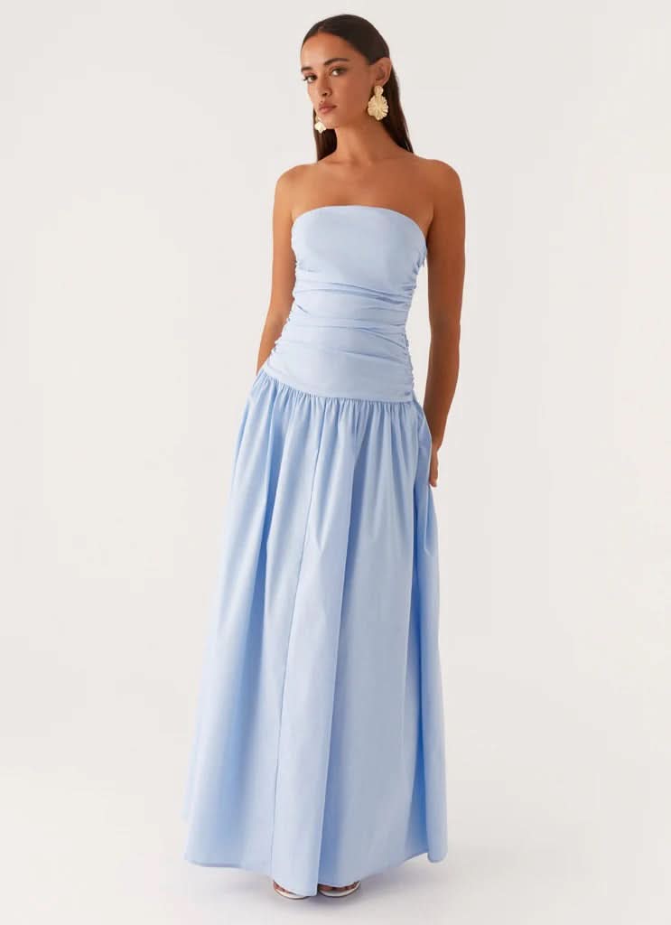 Light blue strapless maxi dress with ruched bodice and flowing pleated skirt